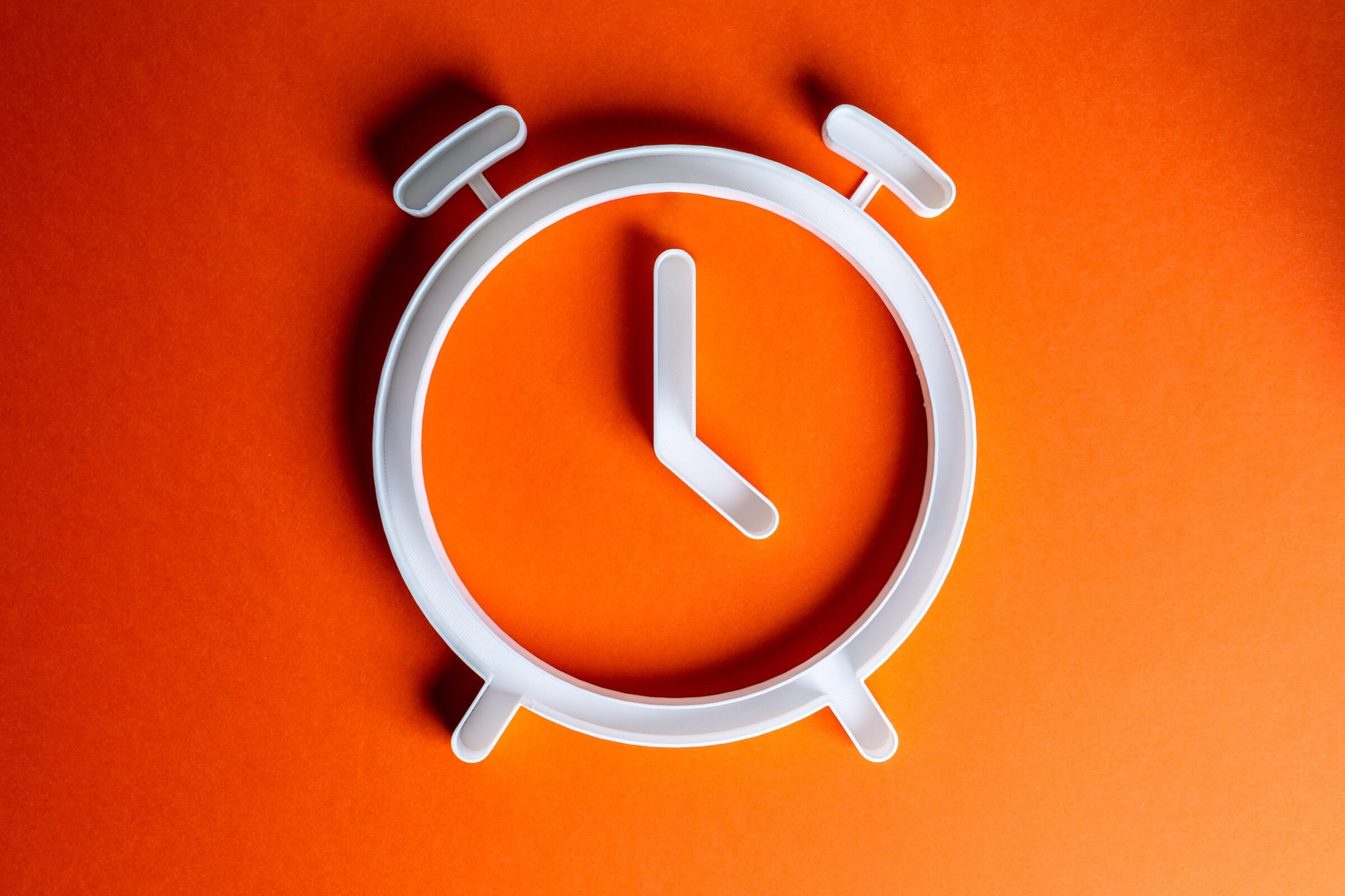 White Clock Shape on Orange Background